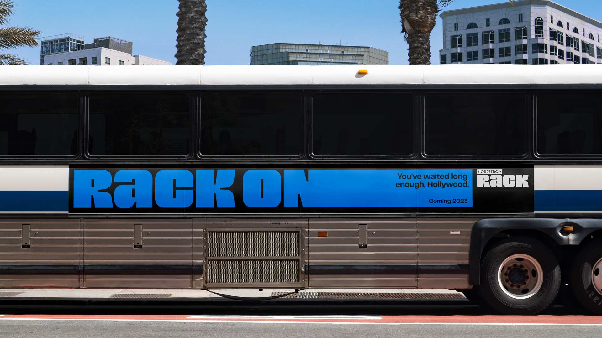 Nordstrom Rack ad on side of bus with stretched typography.
