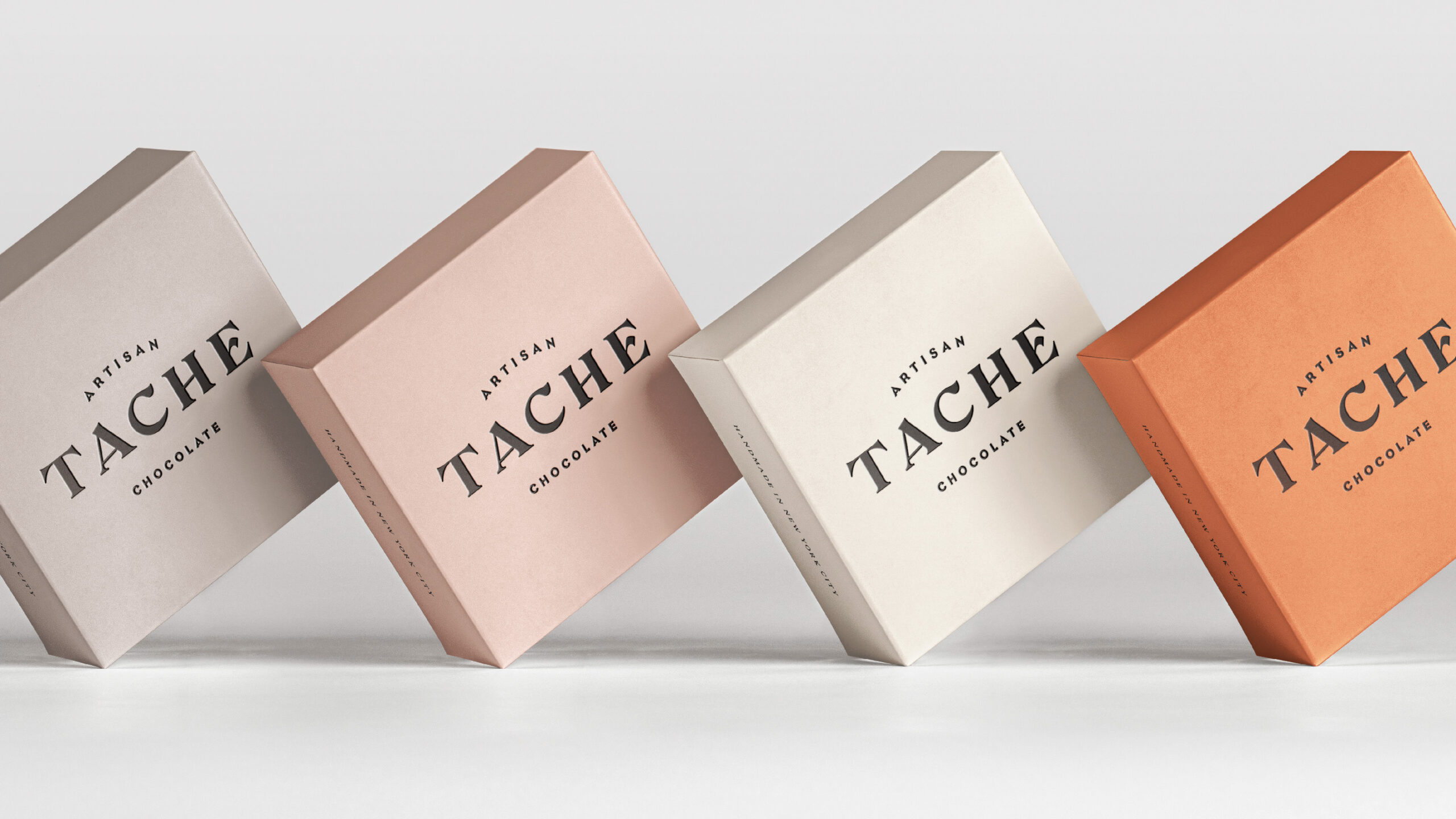 Luxury french chocolate boxes in pink, cream, and white.