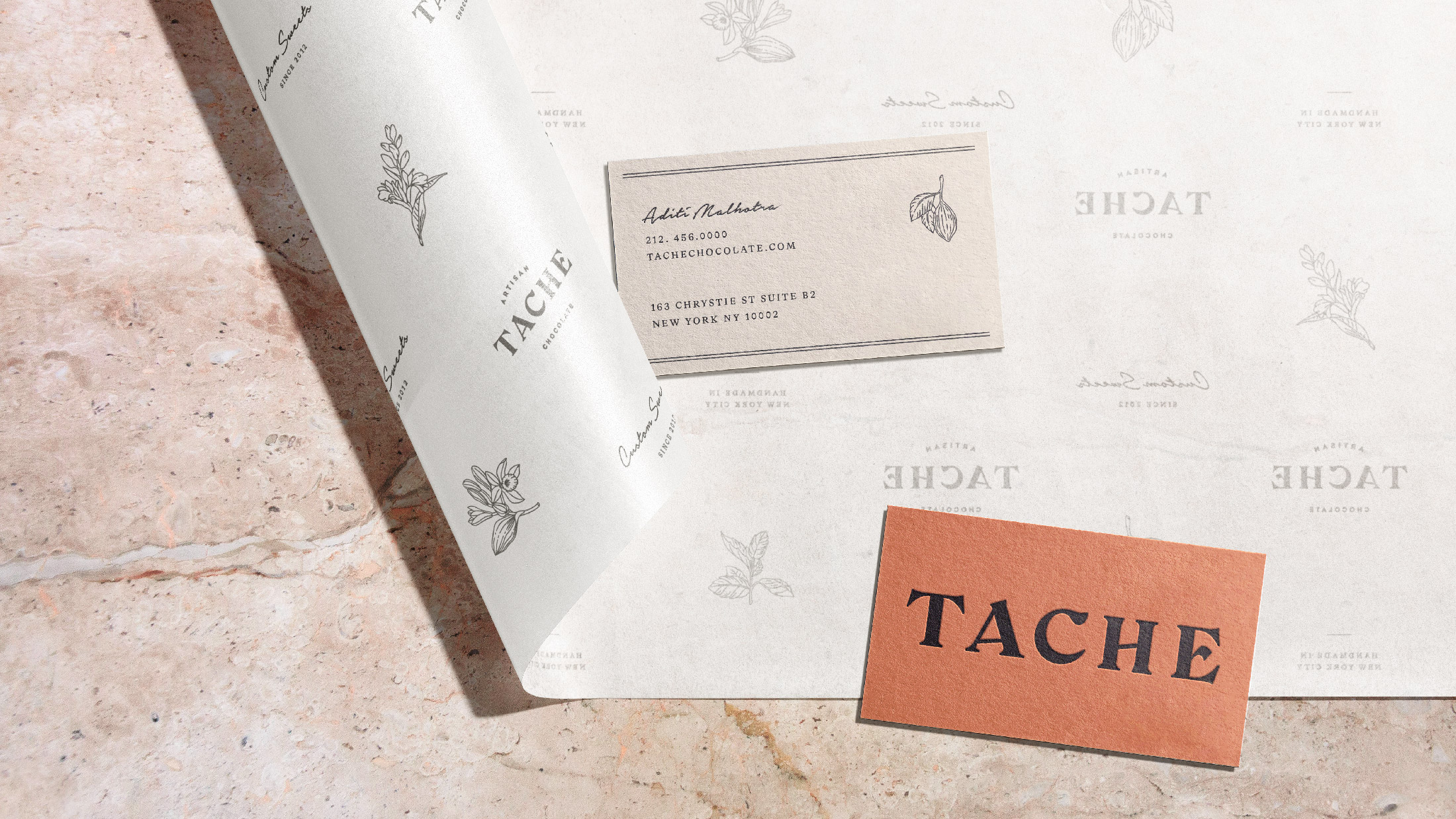 Debossed business cards with floral patterned tissue paper.